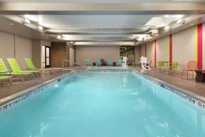 a large swimming pool with blue water in a building at Home2 Suites by Hilton Salt Lake City-East in Salt Lake City