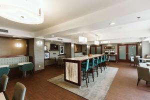 a large dining room with a long table and chairs at Hampton Inn Bismarck in Bismarck