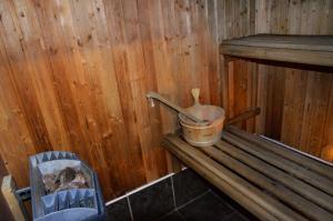 a dirty bathroom with a wooden floor and wooden walls at Sheilas Tourist Hostel in Cork