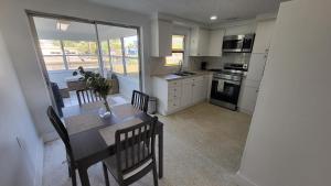 a kitchen with a table and chairs and a dining room at Modern Waterview House in Hudson