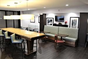 a dining room with a table and chairs and a couch at Hampton Inn Indianapolis NW/Zionsville in Whitestown