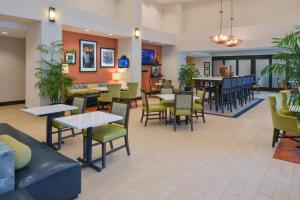 un ristorante con tavoli e sedie e una caffetteria di Hampton Inn & Suites - Ocala a Ocala