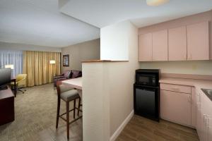 a kitchen and living room in a hotel room at Hampton Inn Rochester Greece in Rochester