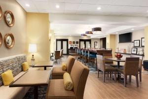 a restaurant with tables and chairs and a bar at Hampton Inn by Hilton Kennewick at Southridge in Kennewick