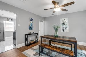 a living room with a ceiling fan and a table at Modern & Cozy East Side Gem ~ Queen Beds ~ Parking in Detroit