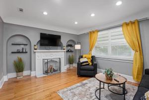 a living room with a fireplace and a couch at Modern & Cozy East Side Gem ~ Queen Beds ~ Parking in Detroit
