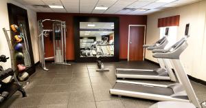 a gym with treadmills and machines in a room at Hampton Inn & Suites Tulsa/Tulsa Hills in Tulsa