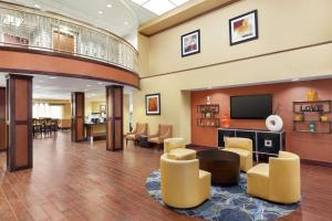 a lobby with a waiting area with a tv and chairs at Hampton by Hilton Oklahoma City I-40 East- Tinker AFB in Midwest City