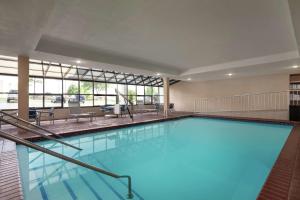 a large pool with blue water in a building at Hampton by Hilton Oklahoma City I-40 East- Tinker AFB in Midwest City