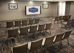 a group of chairs in a room with a screen at Hampton Inn & Suites Philadelphia/Media in Media