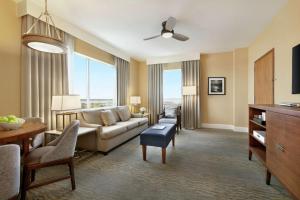 a living room with a couch and a table at Hilton Suites Ocean City Oceanfront in Ocean City