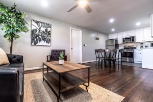 a living room with a couch and a table at Stay Longer, Save 10 percent, Relax in Comfort 15 in Houston