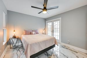 a bedroom with a bed and a ceiling fan at Luxurious Cape Coral Oasis Half Mi to Boat Ramp! in Cape Coral +26 photos