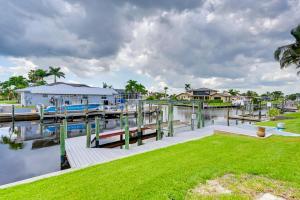 a marina with a dock and a house at Luxurious Cape Coral Oasis Half Mi to Boat Ramp! in Cape Coral