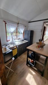 a kitchen with a stove and a sink and a table at ¡Cabaña full equipada para 6! in Guayacán
