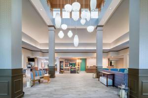 a lobby of a hospital with blue chairs and aospital building at Hilton Garden Inn Augusta in Augusta