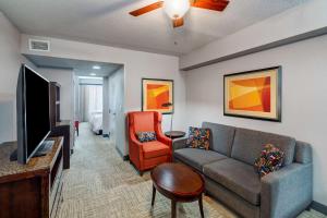 a living room with a couch and a tv at Hilton Garden Inn Augusta in Augusta