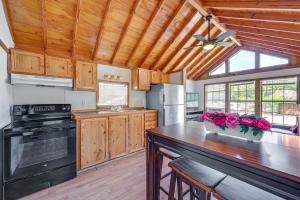 cocina con armarios de madera y ventilador de techo en Everglades City Trailer Cabin with Boat Slip!, en Everglades