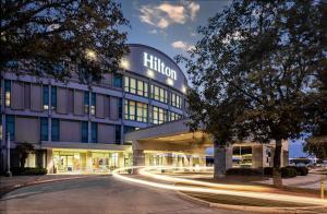 a building with a light trails in front of it at Hilton Austin Airport in Austin