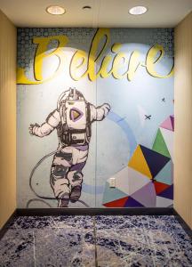 a mural of an astronaut on a wall at Hilton Austin Airport in Austin