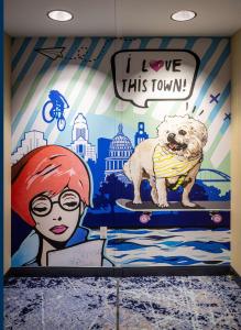 a mural of a girl and a dog on a ramp at Hilton Austin Airport in Austin
