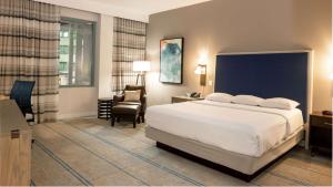 a hotel room with a bed and a chair at Hilton Austin Airport in Austin +37 photos