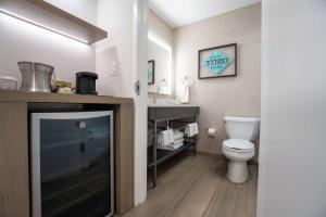 a bathroom with a toilet and a sink at Hilton Austin Airport in Austin