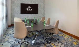 a conference room with a table and chairs at Hilton Austin Airport in Austin
