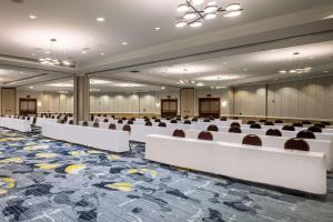 a conference room with white tables and chairs at Hilton Austin Airport in Austin