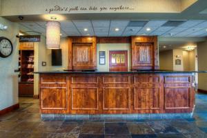 a bar in a store with wooden cabinets at Hilton Garden Inn Boise / Eagle in Eagle