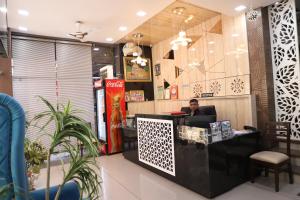 a man sitting at a counter in a restaurant at Hotel Mittal Inn in Ajmer