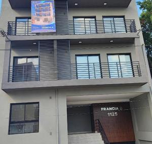 a building with a balcony and a sign on it at Departamento CAMILA in San Salvador de Jujuy