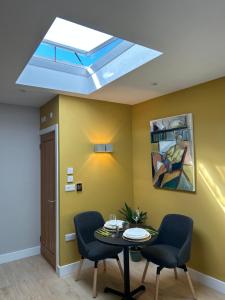 a skylight in a room with a table and chairs at Studio 33 in Chichester