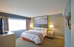 a hotel room with a bed and a large window at DoubleTree by Hilton Huntsville-South in Huntsville