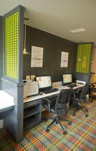 an office with two desks with computers on them at DoubleTree by Hilton Huntsville-South in Huntsville