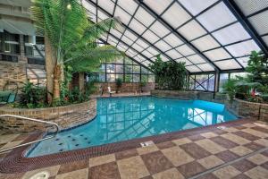 an indoor swimming pool with a glass ceiling at DoubleTree by Hilton Memphis in Memphis