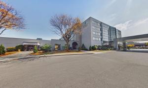 an empty parking lot in front of a building at Embassy Suites by Hilton Milwaukee Brookfield in Brookfield