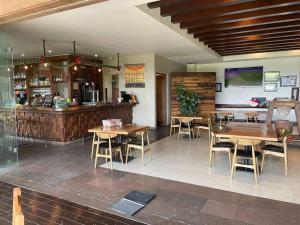a restaurant with wooden tables and chairs and a bar at Luxury at a great price in San Miguel in San Miguel de Allende