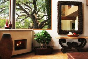 a living room with a fireplace and a mirror at Luxury at a great price in San Miguel in San Miguel de Allende +19 photos
