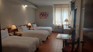 A bed or beds in a room at Lima Wasi Hotel Miraflores