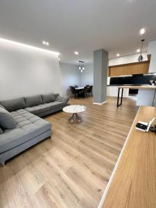 a living room with a couch and a table at George apartments2023 in Korçë