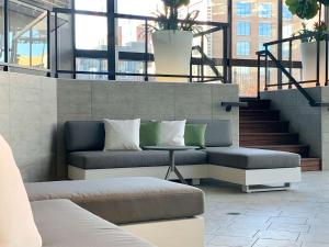 a living room with a couch and a table at DoubleTree By Hilton Montreal in Montreal