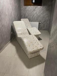 a bench sitting in a corner of a room at Apartman IKS-M & Spa in Zlatibor