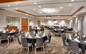 a conference room with tables and chairs in it at Hilton Garden Inn Salt Lake City/Sandy in Sandy