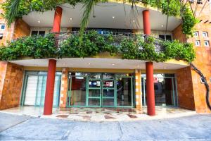 a building with red columns and plants on it at Hotel Santa Maria in Cancún