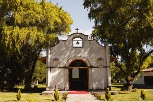una pequeña iglesia con una cruz en el frente en Ensenada Hotel y Campo Asociado Casa Andina, en Cajamarca
