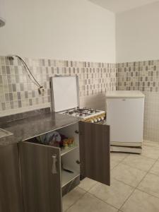 a kitchen with a stove and a refrigerator at complexe doha marjane tetouan in Tétouan +7 photos