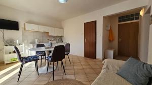 a kitchen and living room with a table and chairs at Apartments Gardelin Paklenica in Seline +70 photos