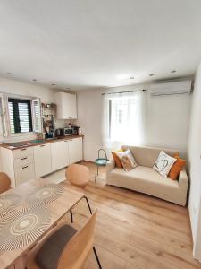 a living room with a couch and a table at Apartment LIPA in Slatine +19 photos