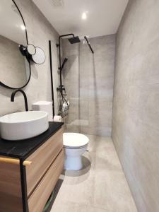 a bathroom with a sink and a toilet at Apartment LIPA in Slatine